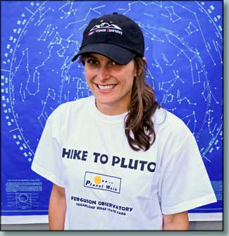 Person wearing a hat and T-shirt that can be purchased at the RFO store. The black hat features the RFO logo, while the white "Hike to Pluto" shirt highlights RFO's Planet Walk.