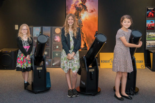 Three children with their new telescopes through RFO's Striking Sparks program.